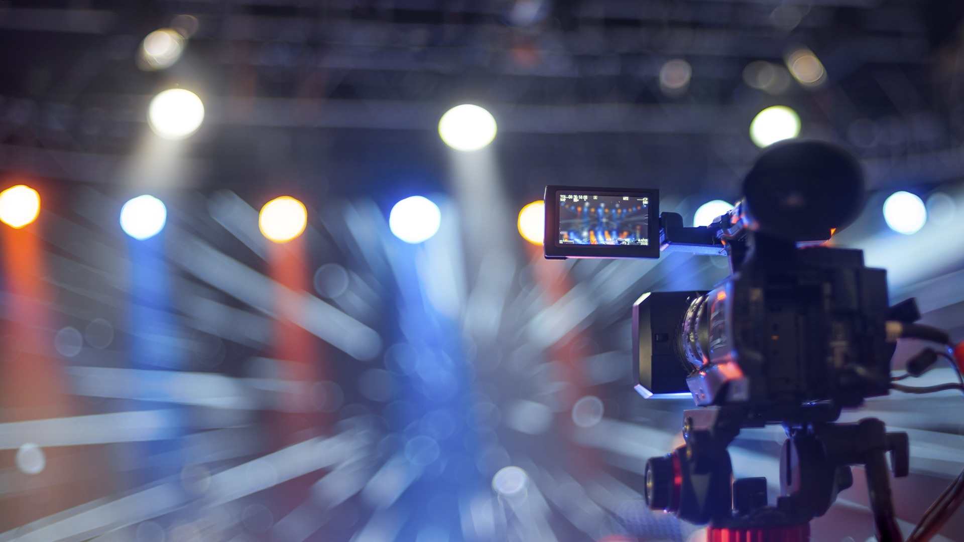 Broadcast camera operator covering a live studio production